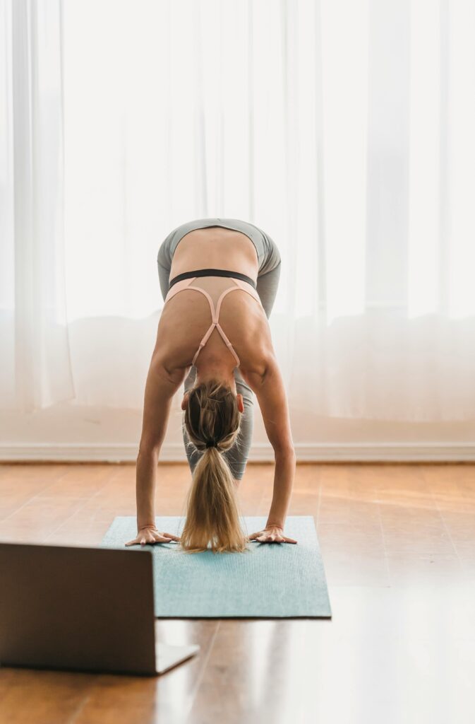 Uttanasana (Forward Fold) yoga pose stretching the hamstrings and spine, promoting relaxation and stress relief